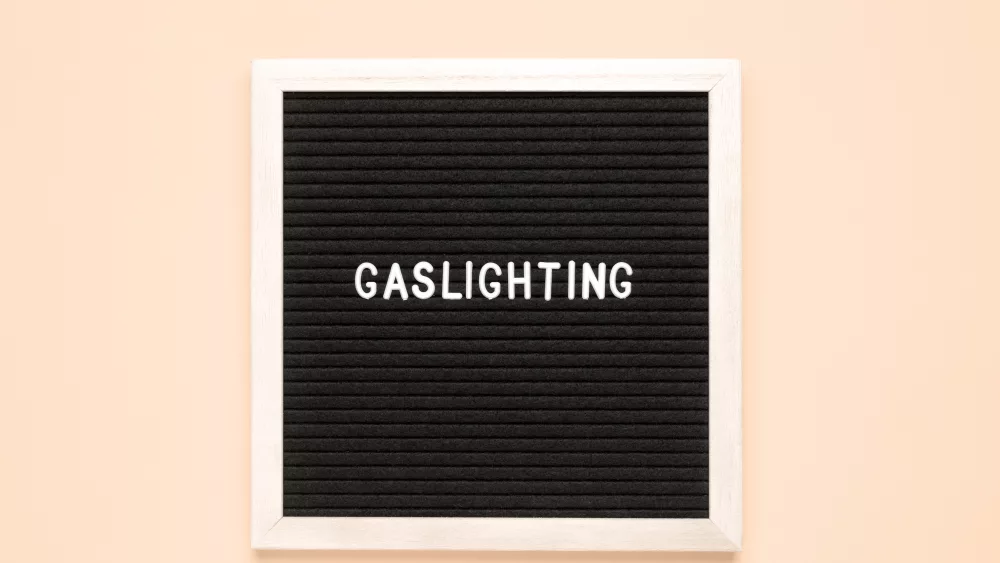 the-word-gaslighting-on-black-letter-board-over-isolated-beige-background-psychological-violence-concept