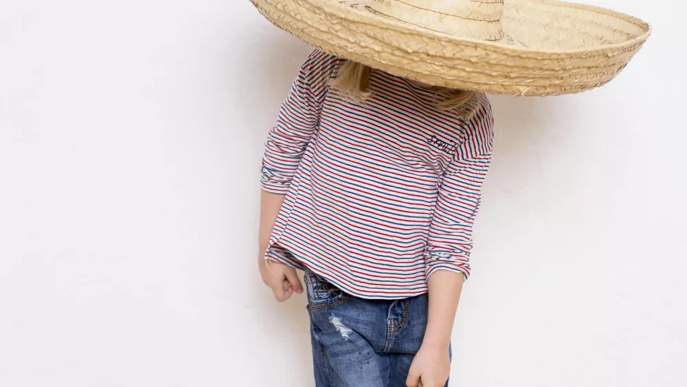 young-girl-wearing-sombrero-pointing-to-feet