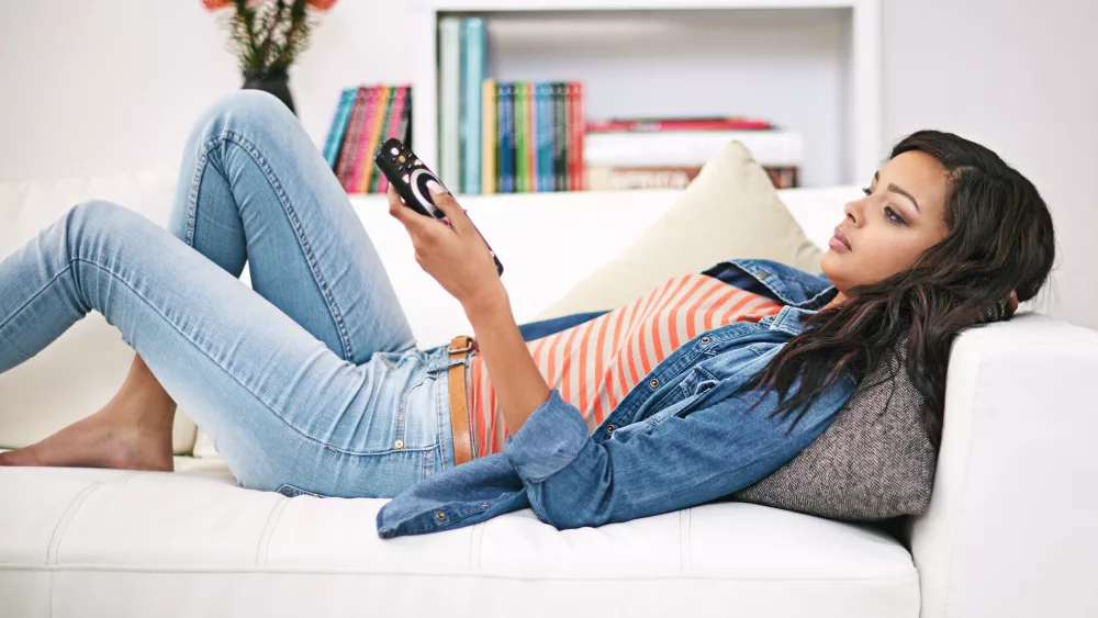 channel-surfing-shot-of-a-young-woman-watching-television-at-home