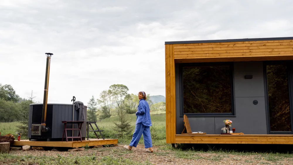 woman-resting-on-nature-in-wooden-house-with-hot-tub