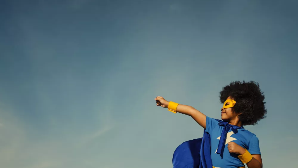 girl-with-afro-playing-superhero