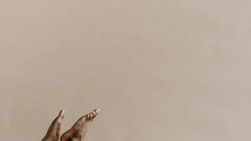 black-man-with-his-feet-and-hands-in-the-air