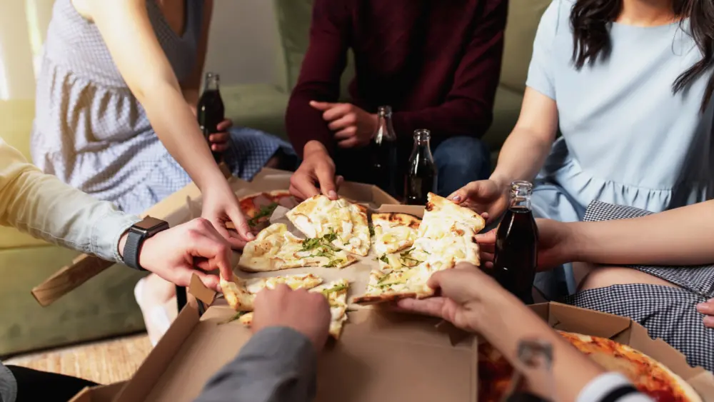 pizza-party-group-of-friends-chatting-eating-pizza-drinking-sweet-soda-water
