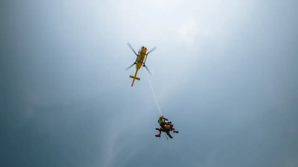 paramedics-hanging-on-rope-under-rescue-helicopter