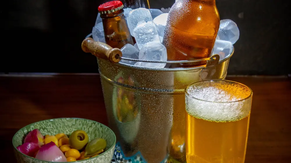 a-vertical-shot-of-a-glass-of-beer-snacks-and-bo-2025-10-16-04-11-59-utc