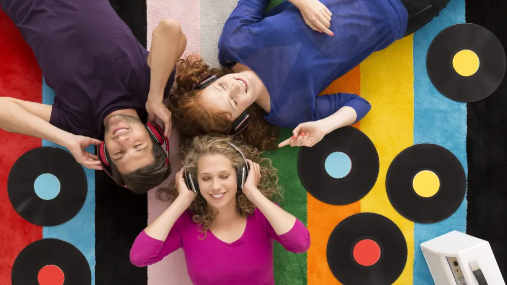 people-lying-on-carpet-and-listening-to-music