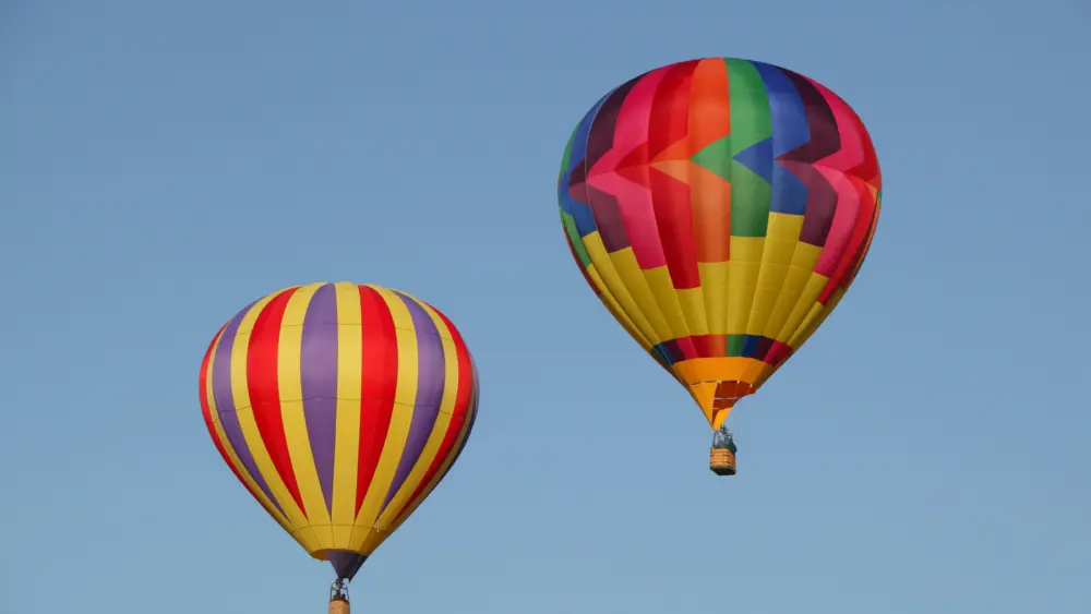 low-angle-view-of-hot-air-balloons-against-blue-sk-2026-01-11-09-35-28-utc