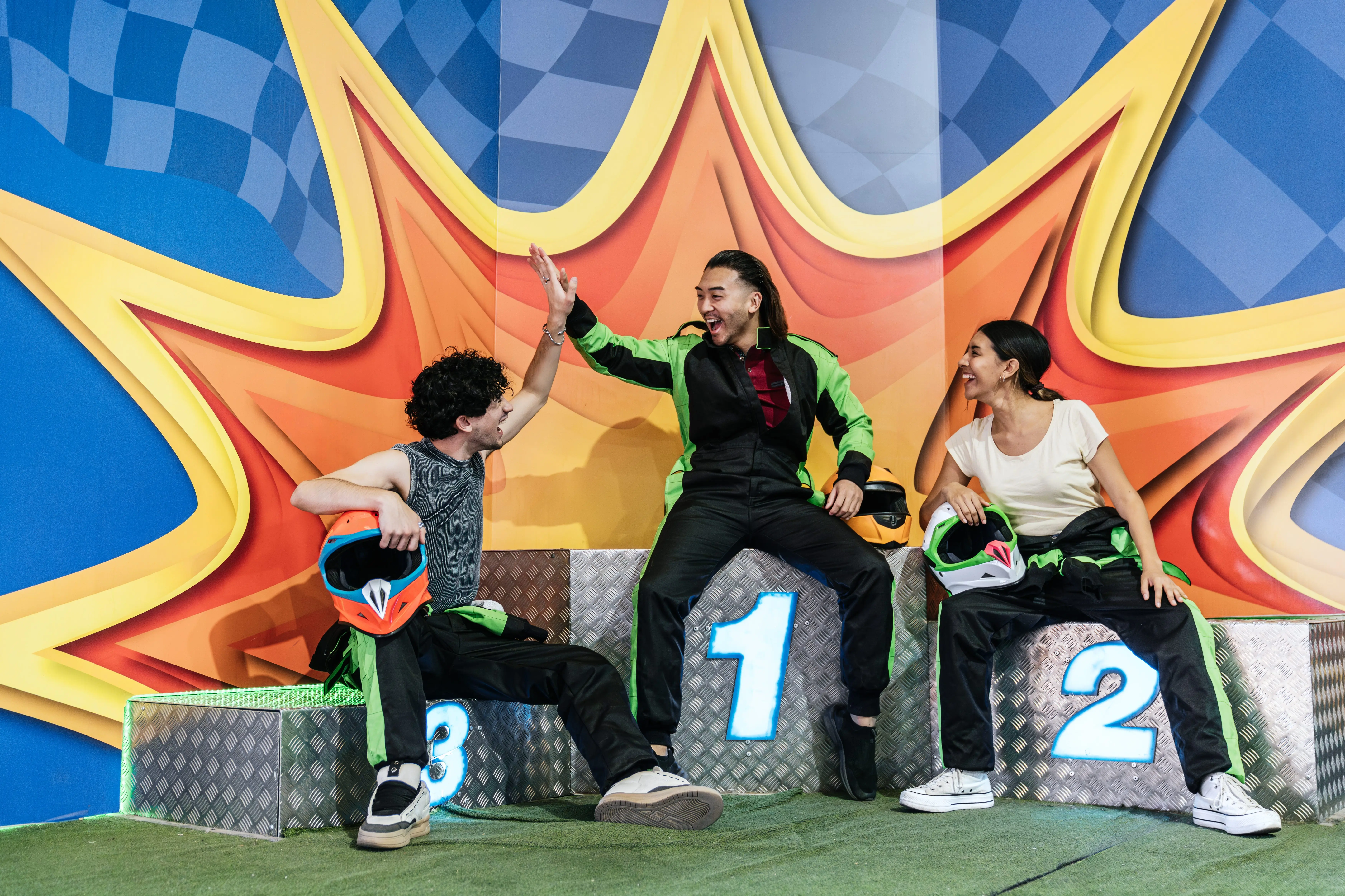 friends-celebrating-go-kart-racing-victory-on-podium