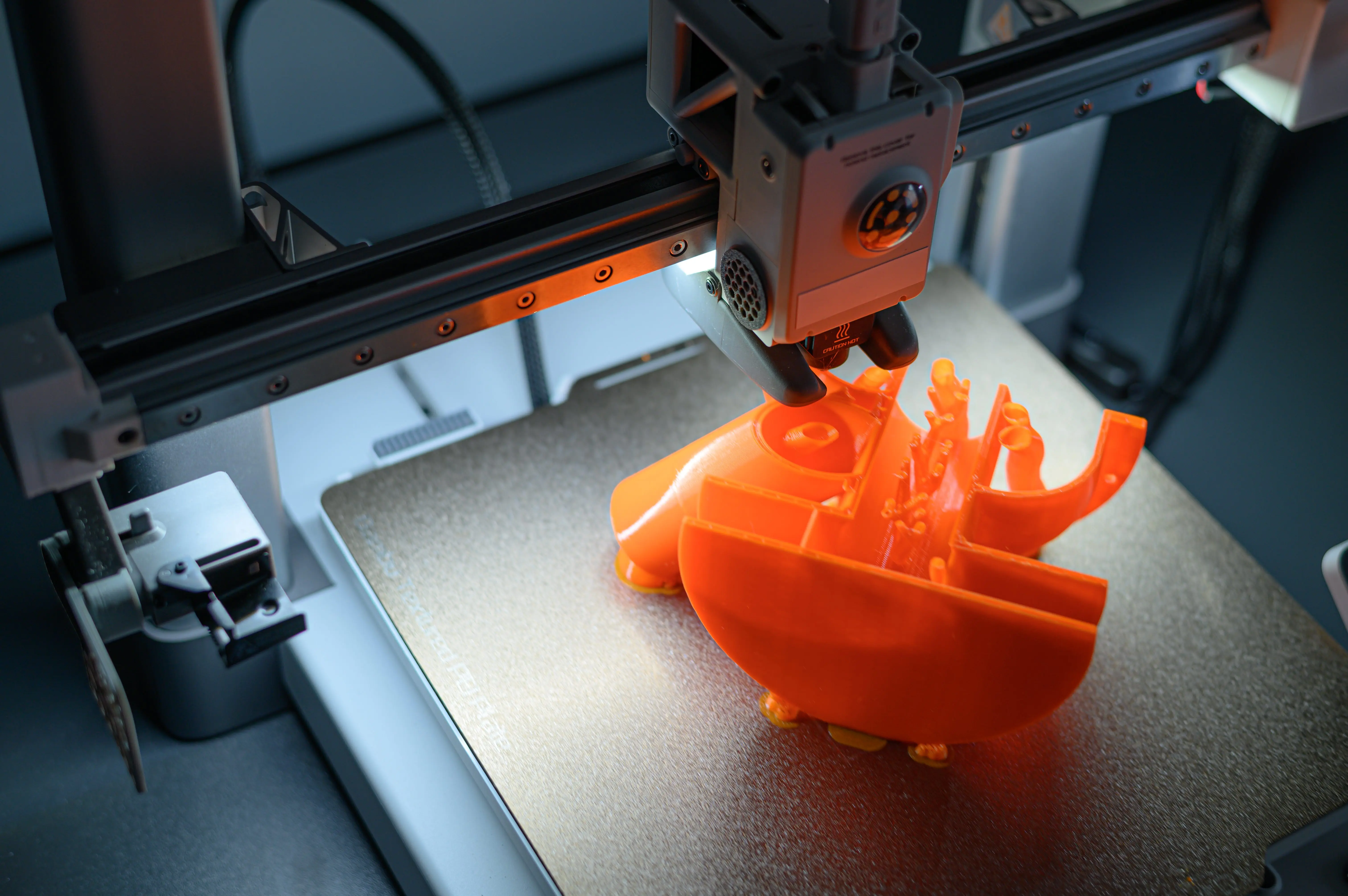 3d-printer-creating-vibrant-orange-prototype-model