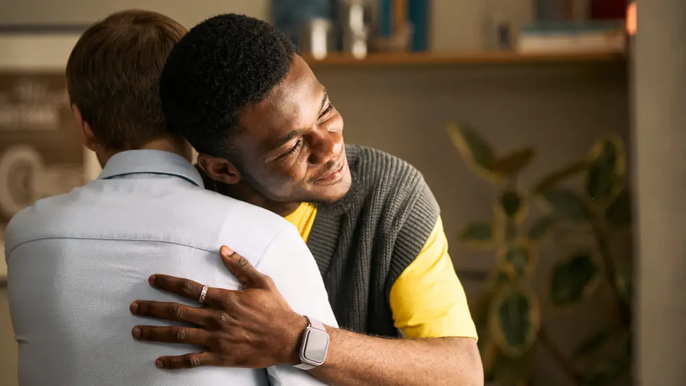 adult-men-embracing-in-supportive-friendship-and-trust