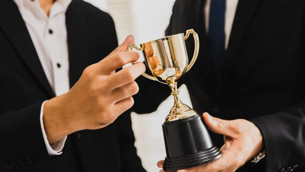 cheerful-business-team-winning-trophy