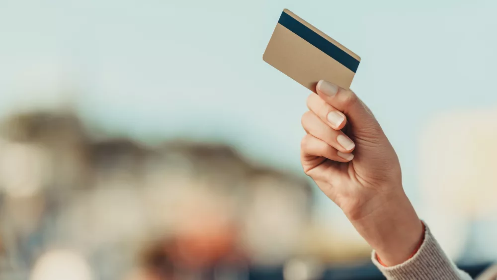 cropped-shot-of-woman-holding-credit-card