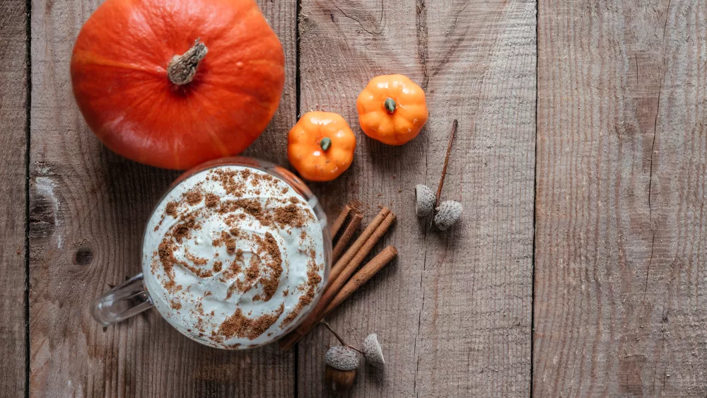 autumn-pumpkin-spice-hot-drink-on-wooden-background-top-view