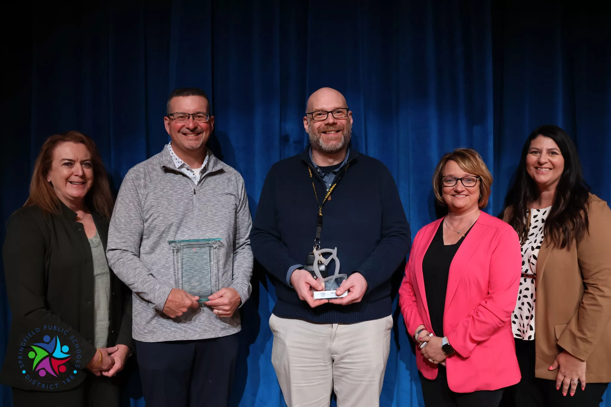 Jason Wind and Jason Potter (Left to right) receiving their Horace Mann awards for 2024 with Superintendent Jennifer Gill, Horace Mann CEO Marita Zuraitis, and Katie Hageman (Credit: District 186 Facebook)