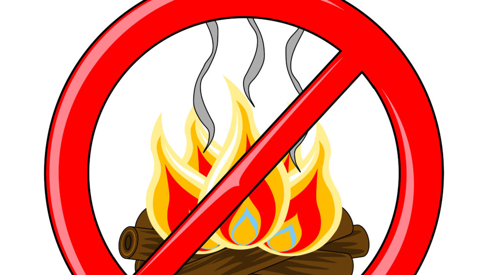 isolatedlogcampfirewithburningflamesandsmoketrailsinside