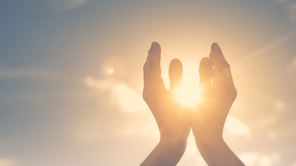 womanhandsholdingthesunatdawn-freedomandspirituality