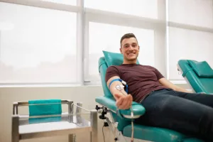 young-man-lying-while-donating-blood-at-the-blood-bank