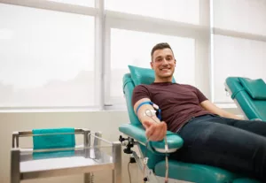 young-man-lying-while-donating-blood-at-the-blood-bank