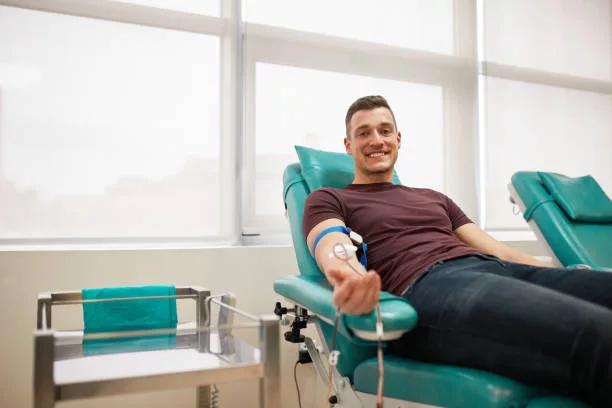 young-man-lying-while-donating-blood-at-the-blood-bank