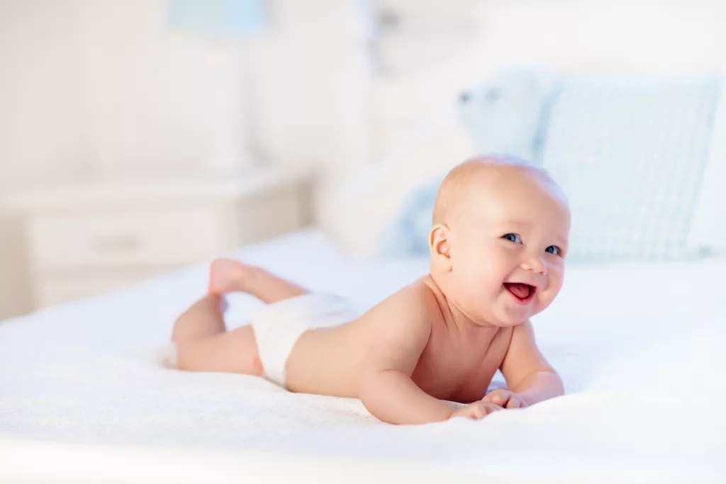 babyboywearingdiaperinwhitesunnybedroom-newbornchild