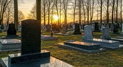 aquietcemeteryinspring-ablankdarkmarbletombstone
