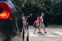 childrennexttoacarwalkingthroughpedestriancrossingto