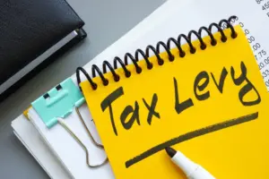 stackofdocumentsandnotepadwithinscriptiontaxlevy