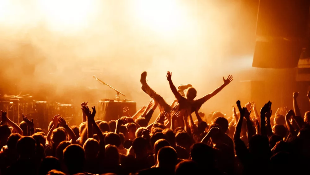 Crowd surfing during a musical performance