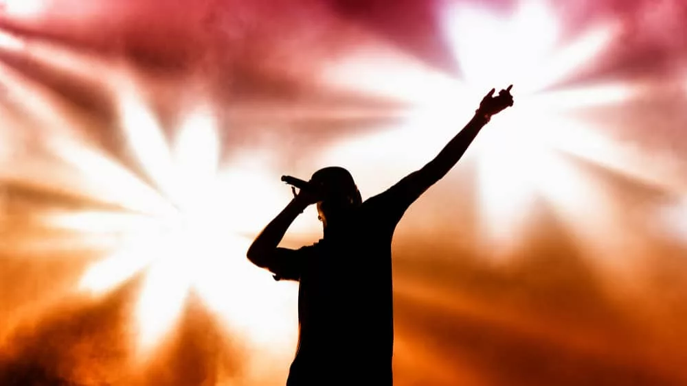 rapper on stage performing ;silhouette