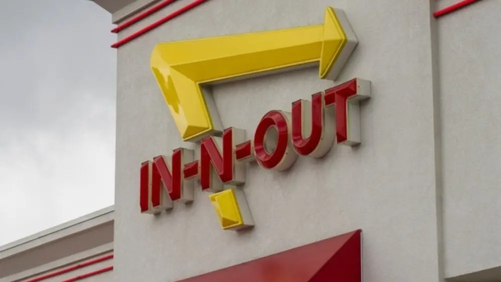 In-N-Out Burger sign is seen at the entrance to its restaurant in Grants Pass^ Oregon. In-N-Out Burger is an American fast food chain based in Irvine^ California.