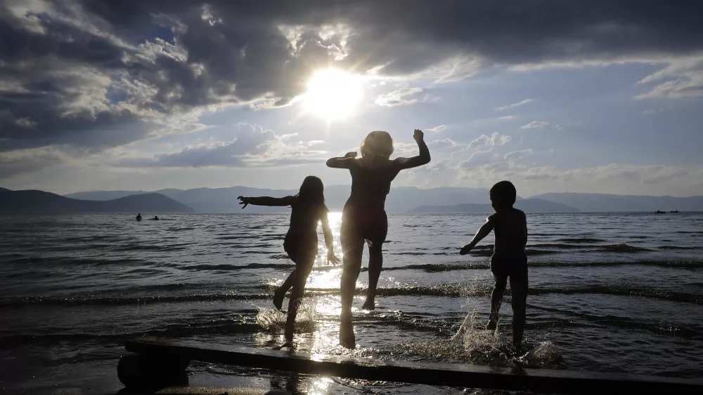 kids-play-at-prespa-lake-to-cool-off-during-a-hot-summer-day-in-prespa