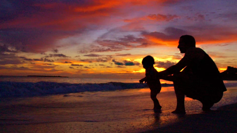 father-and-son-play-on-shore-at-sunrise