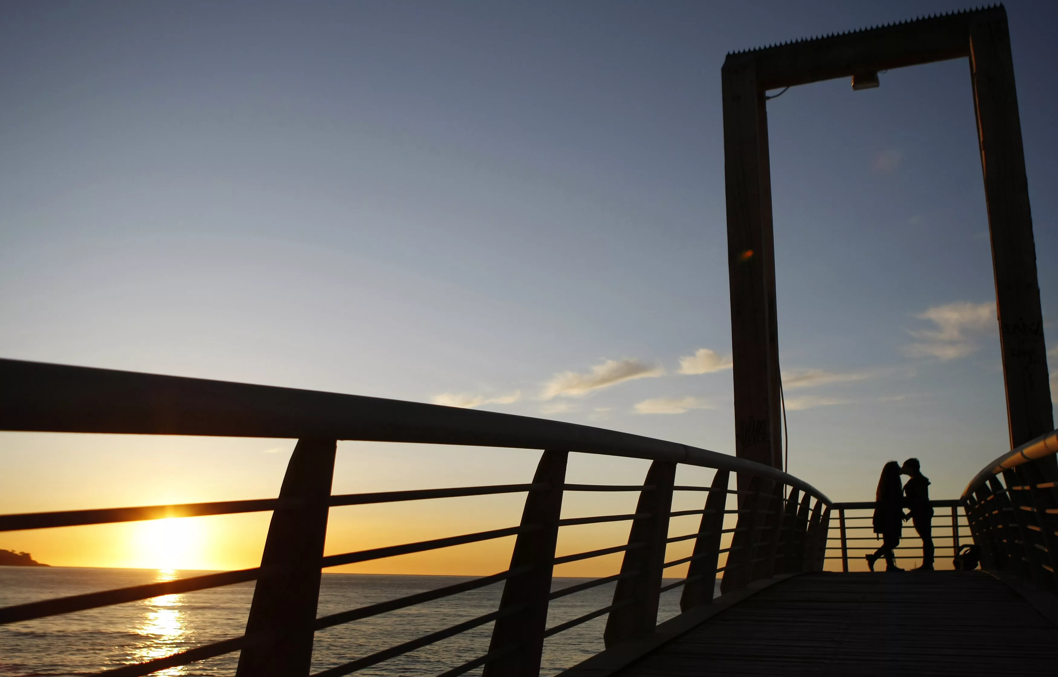a-couple-kiss-in-the-sunset-during-the-start-of-winter-solstice-in-valparaiso-city