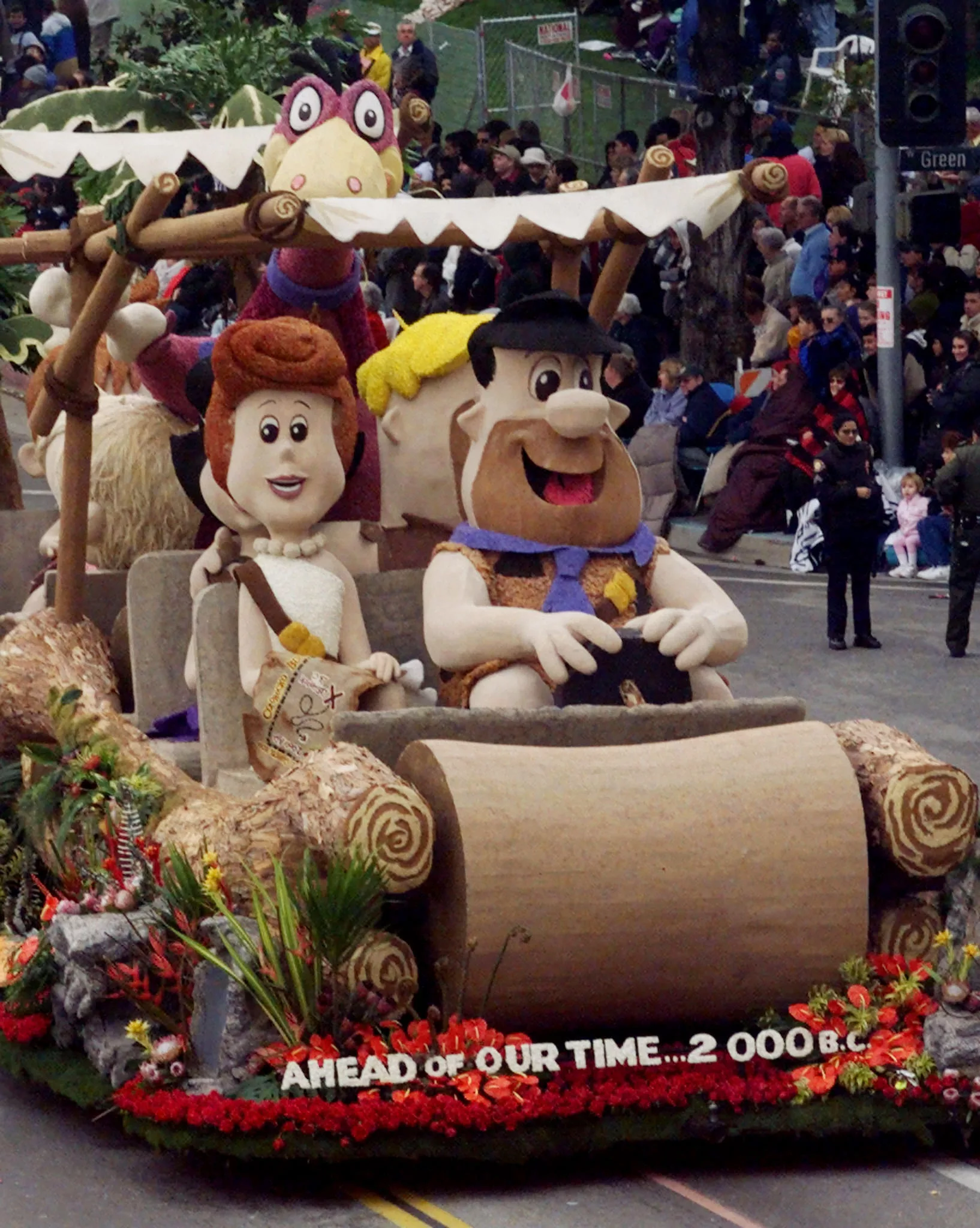 cartoon-characters-fred-and-wilma-flintstonealong-with-their-pet-dino-are-featured-on-a-float-from