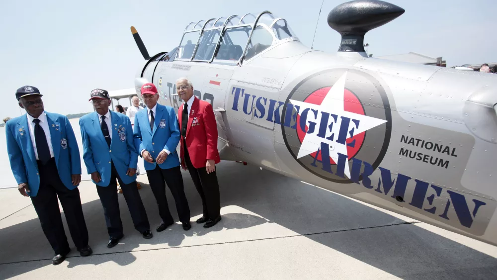tuskegee-airmen-pilots-lt-colonel-ross-lt-col-jefferson-lt-col-stewart-and-colonel-mcgee-stand-next-to-ay-6-texan-fighter-plane-during-ceremony-to-honor-the-airmen-at-selfridge-national-airbase