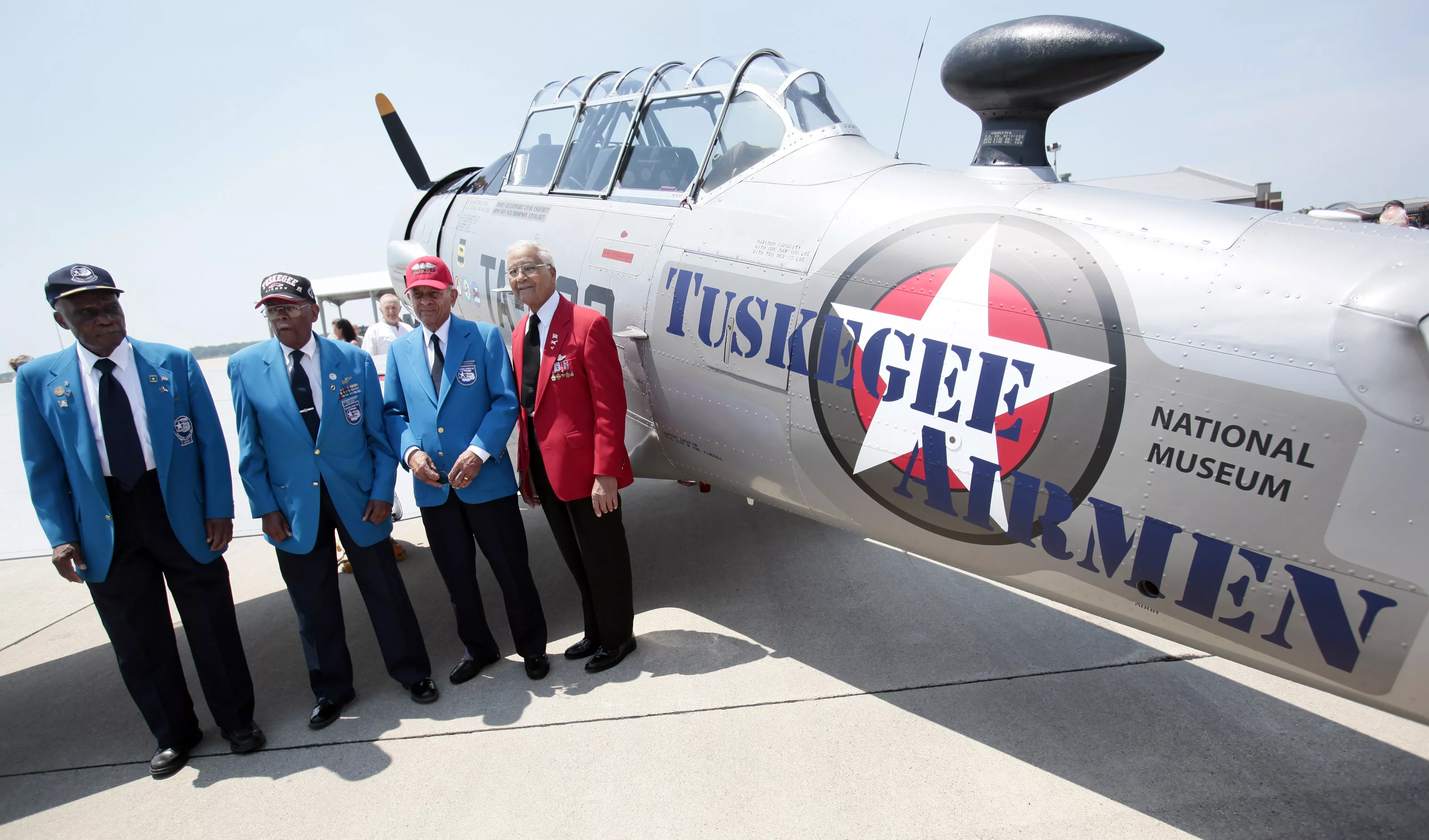 tuskegee-airmen-pilots-lt-colonel-ross-lt-col-jefferson-lt-col-stewart-and-colonel-mcgee-stand-next-to-ay-6-texan-fighter-plane-during-ceremony-to-honor-the-airmen-at-selfridge-national-airbase