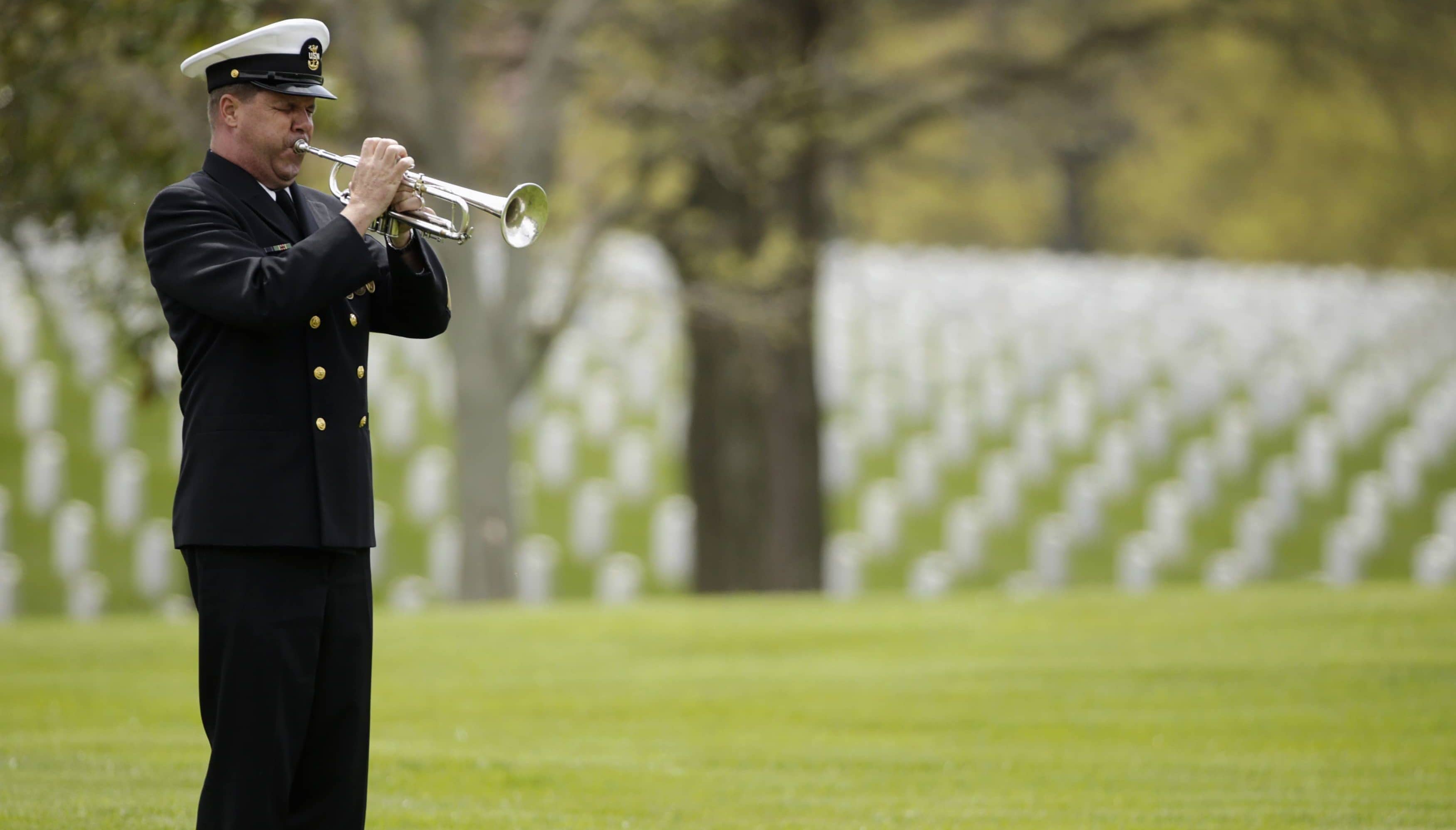 a-u-s-navy-band-bugler-plays-taps-for-u-s-navy-master-at-arms-second-class-mark-mayo-during-his-burial-service-at-arlington-national-cemetery-in-virginia