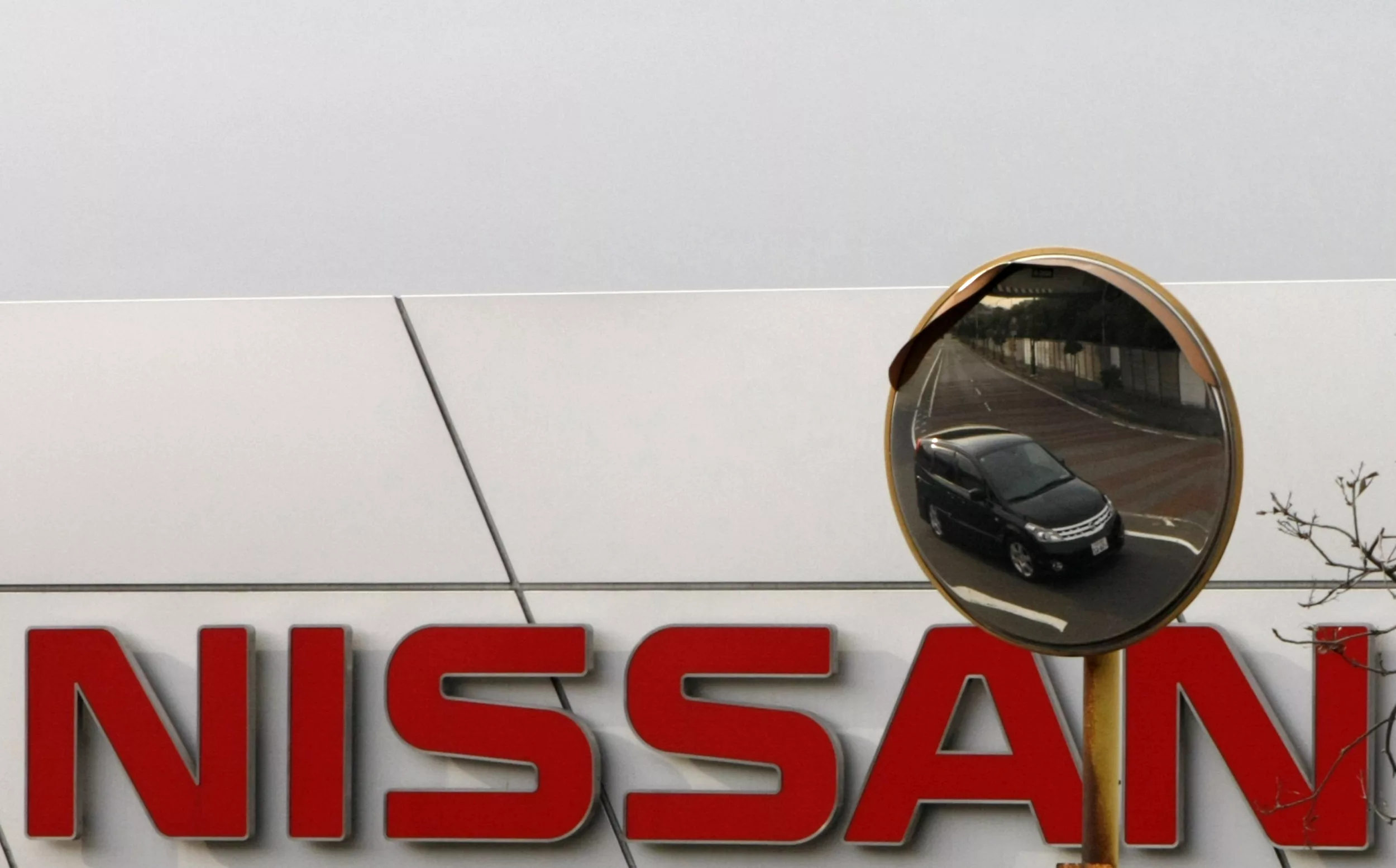 a-nissan-car-is-reflected-in-a-mirror-outside-a-nissan-motor-co-factory-in-yokosuka