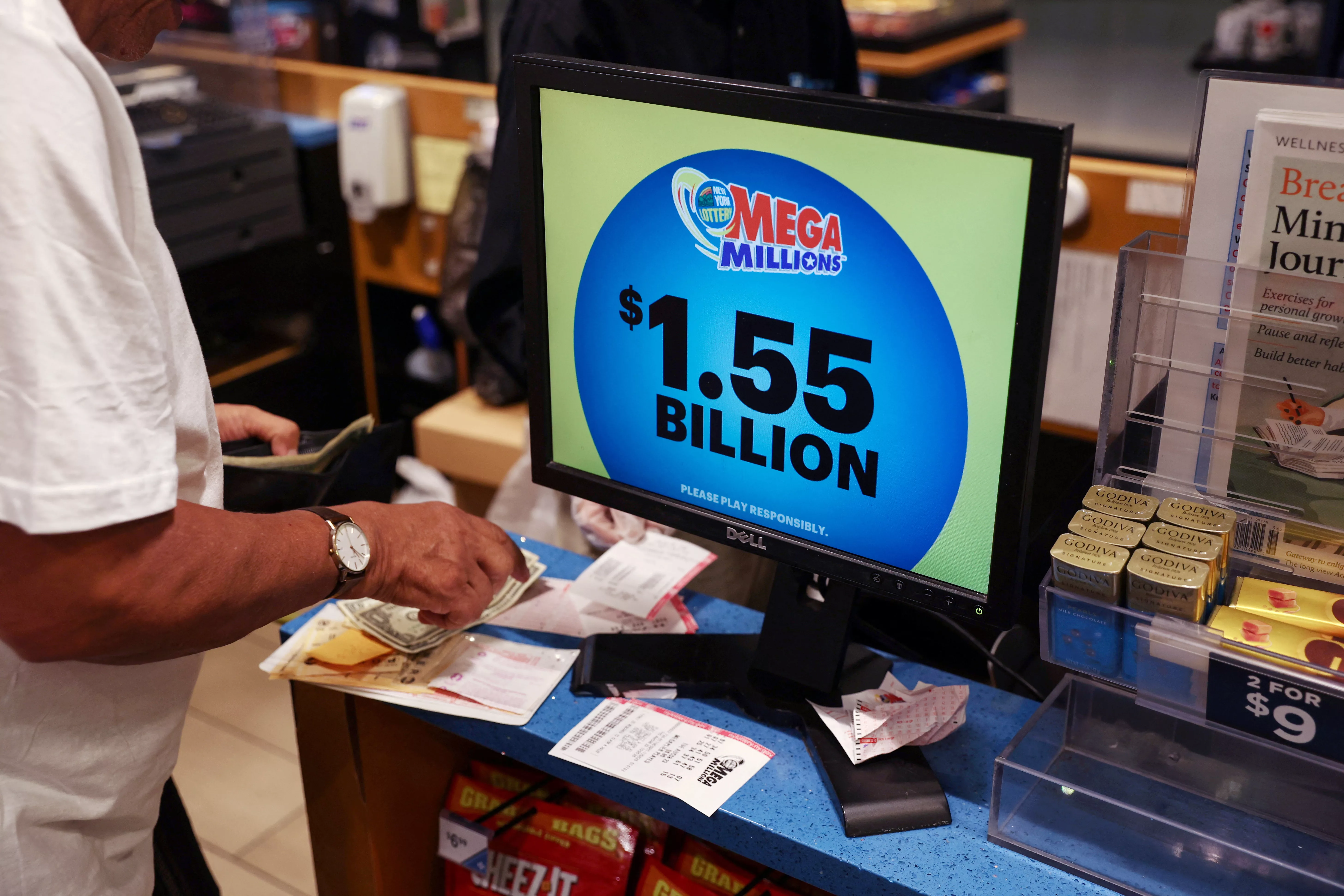 the-display-in-a-store-shows-the-mega-millions-lottery-jackpot-at-1-55-billion