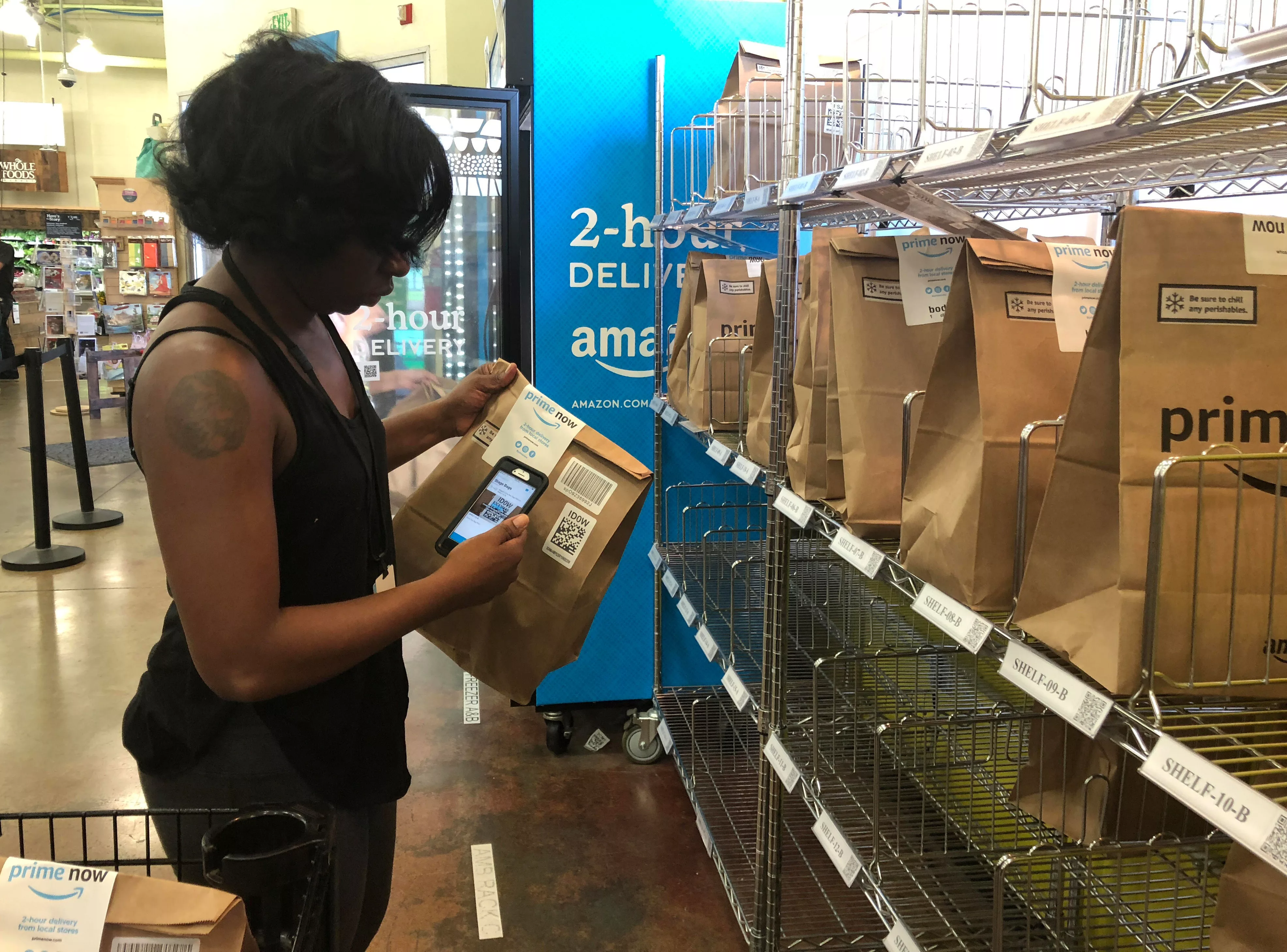 a-whole-foods-shopper-prepares-a-delivery-order-at-the-groceros-rockwood-commons-store-in-cincinnati