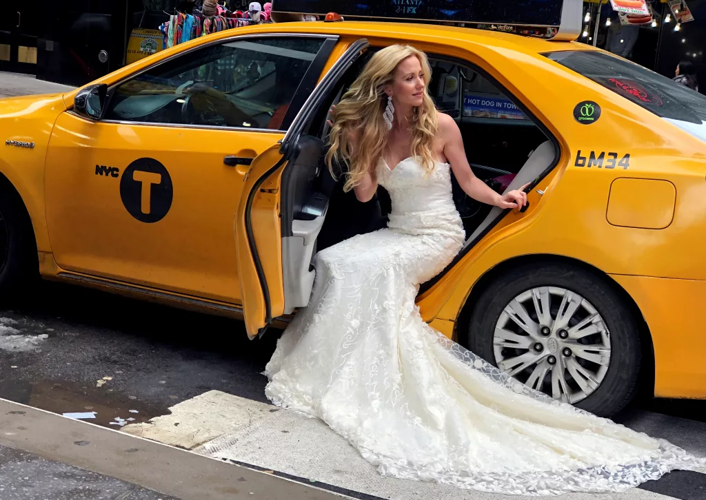 a-model-in-bridal-gown-emerges-from-a-taxi-cab-in-times-square-in-new-york-city