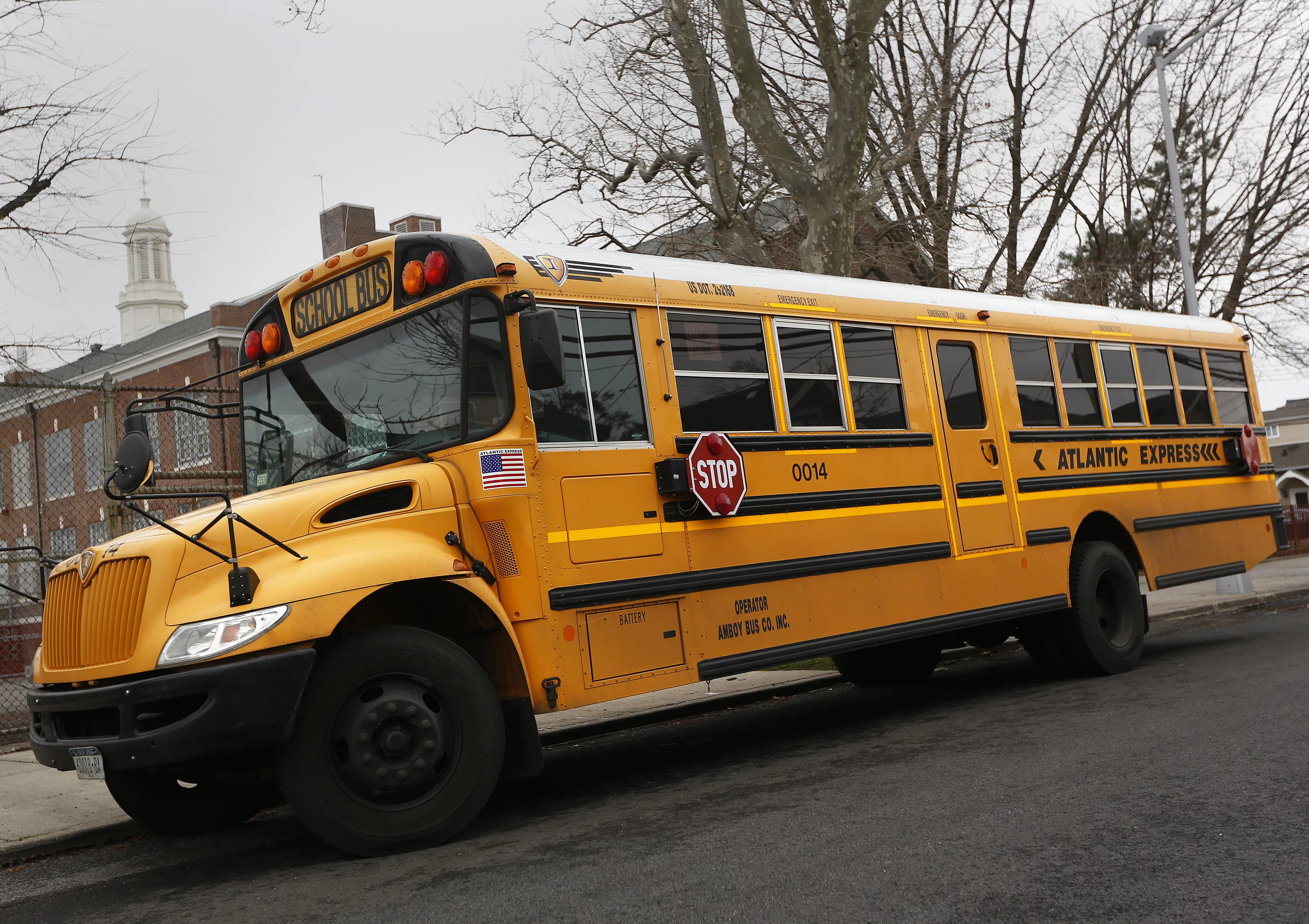 a-school-bus-used-for-transporting-new-york-city-public-school-students-is-seen-parked-in-front-of-a-school-in-the-queens-borough-of-new-york