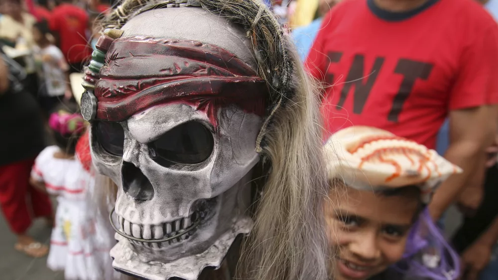 a-child-holds-a-toy-skull-during-the-celebration-of-international-human-rights-day-in-managua