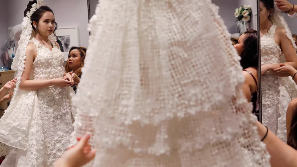 a-model-is-fitted-for-the-14th-annual-toilet-paper-wedding-dress-contest-in-manhattan