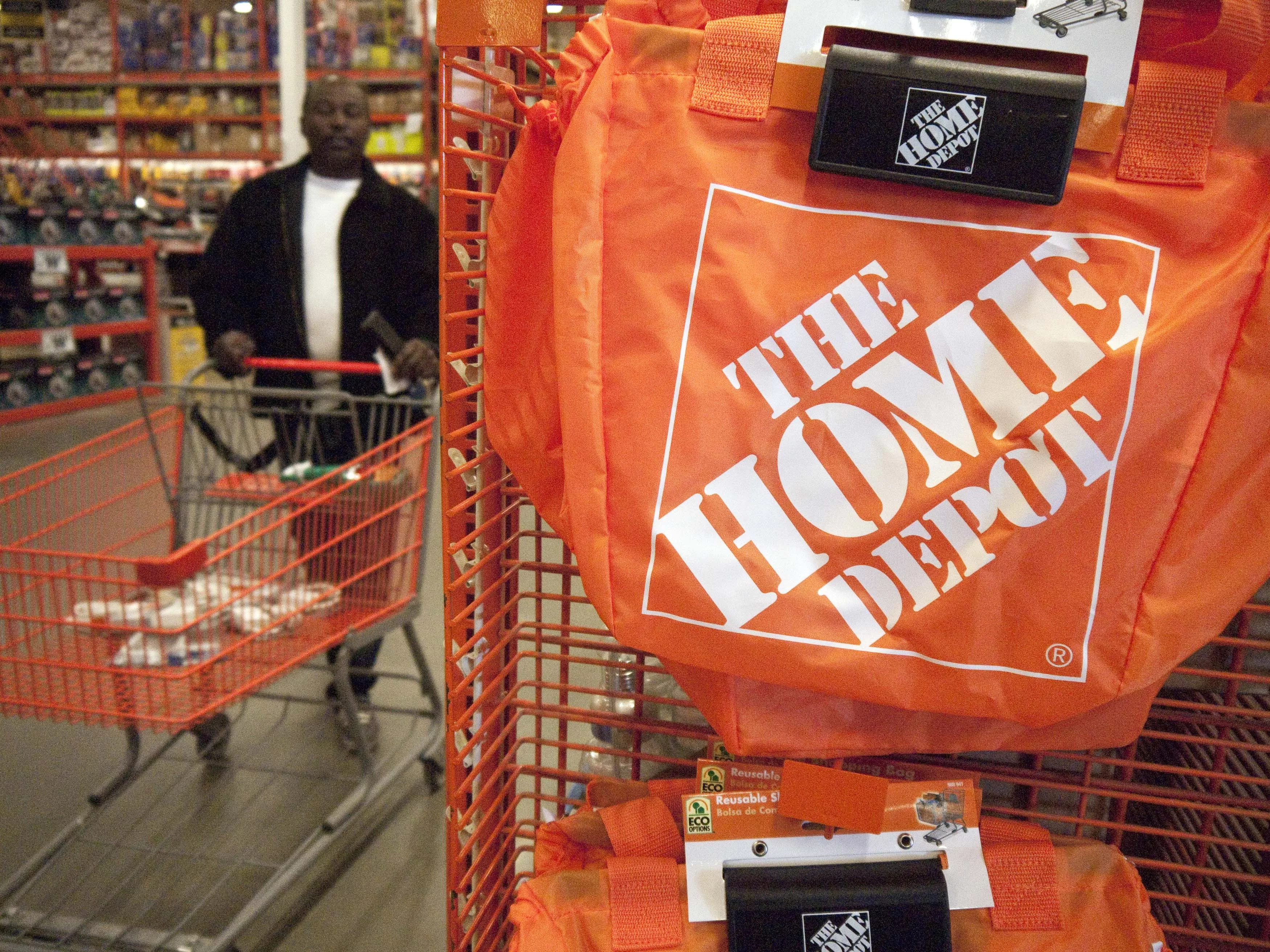 a-customer-wheels-a-cart-through-a-home-depot-store-in-washington