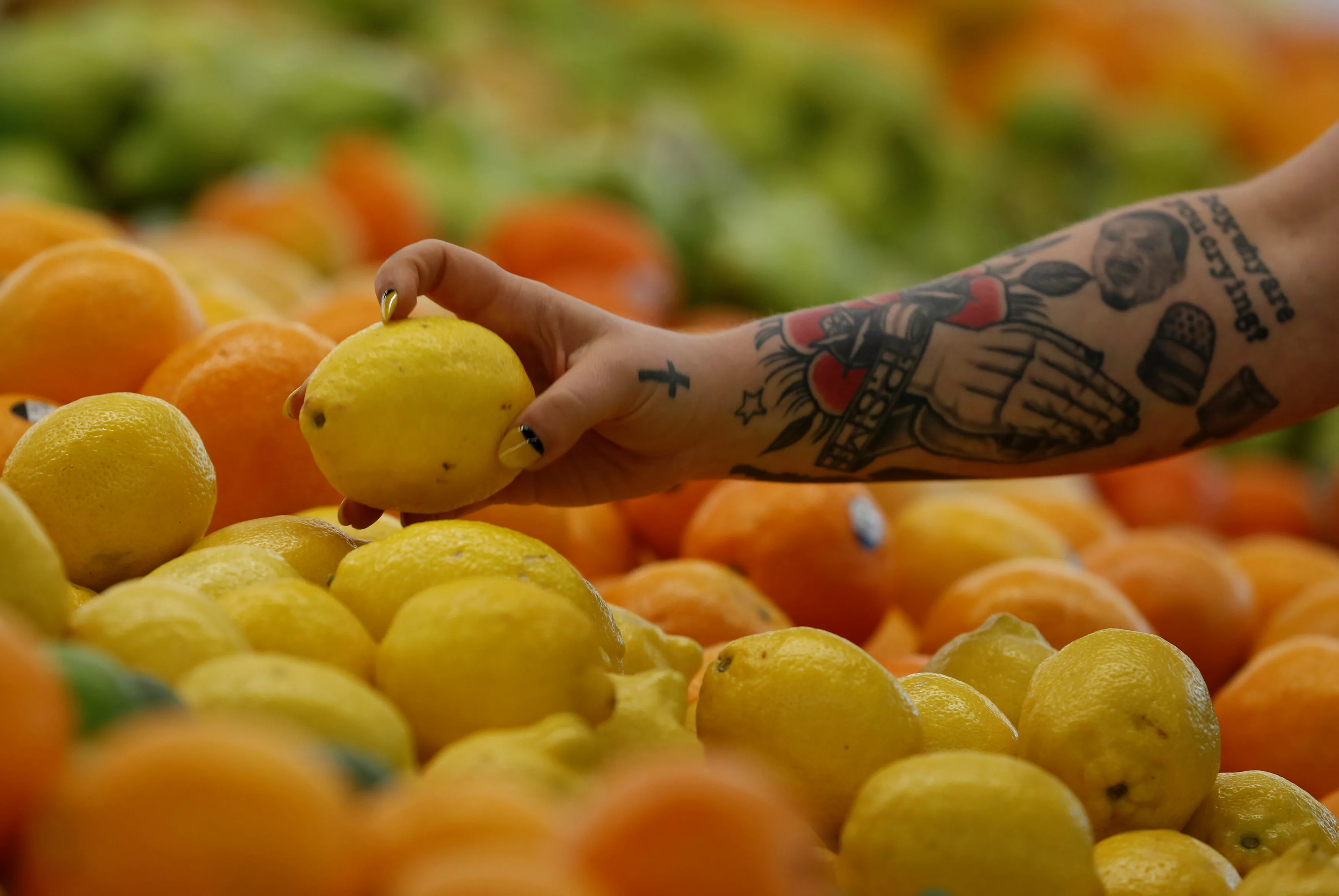 an-employee-checks-a-lemon-at-a-365-by-whole-foods-market-grocery-store-ahead-of-its-opening-day-in-los-angeles