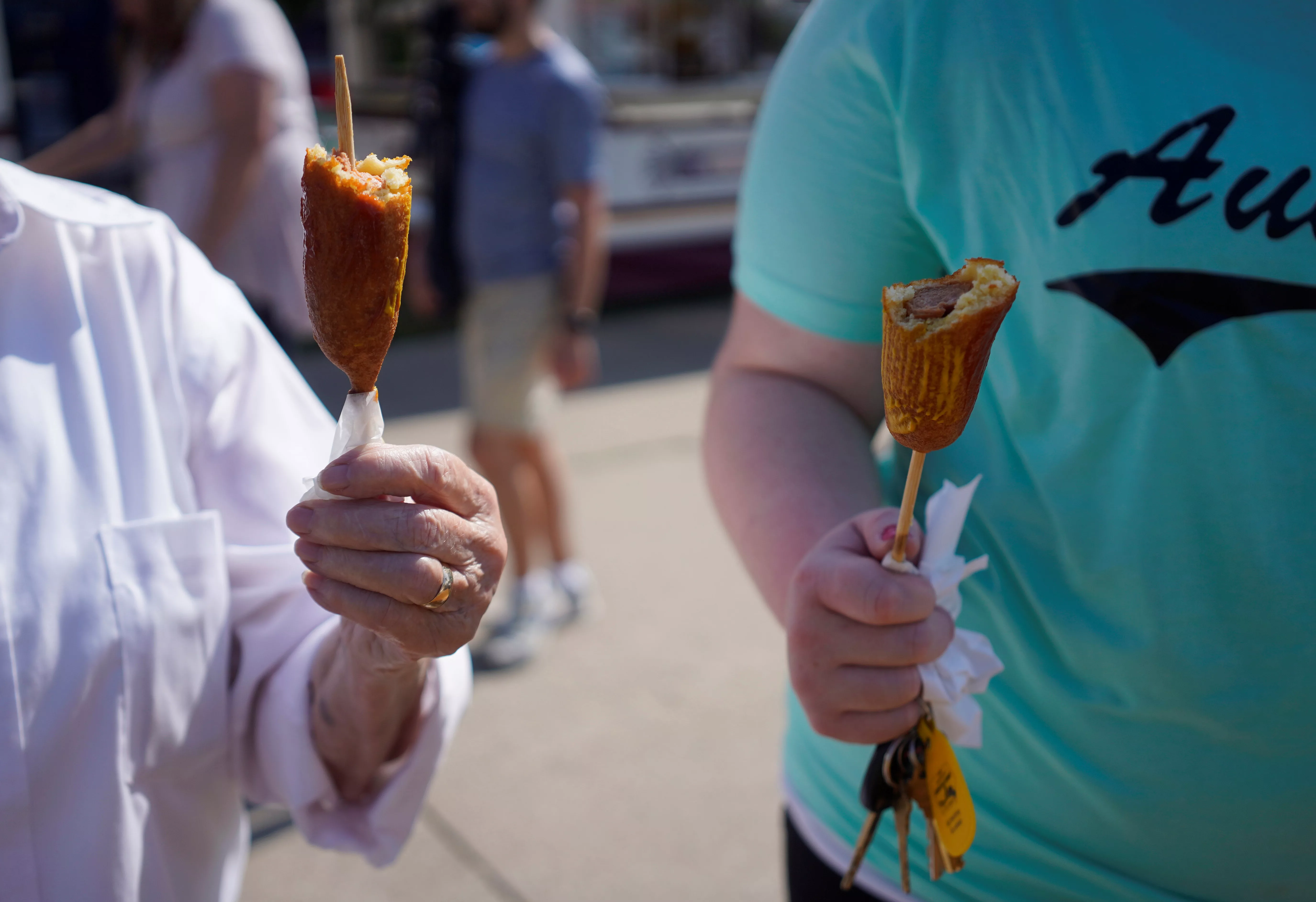 people-hold-corn-dogs-during-preparations-for-the-iowa-state-fair-in-des-moines