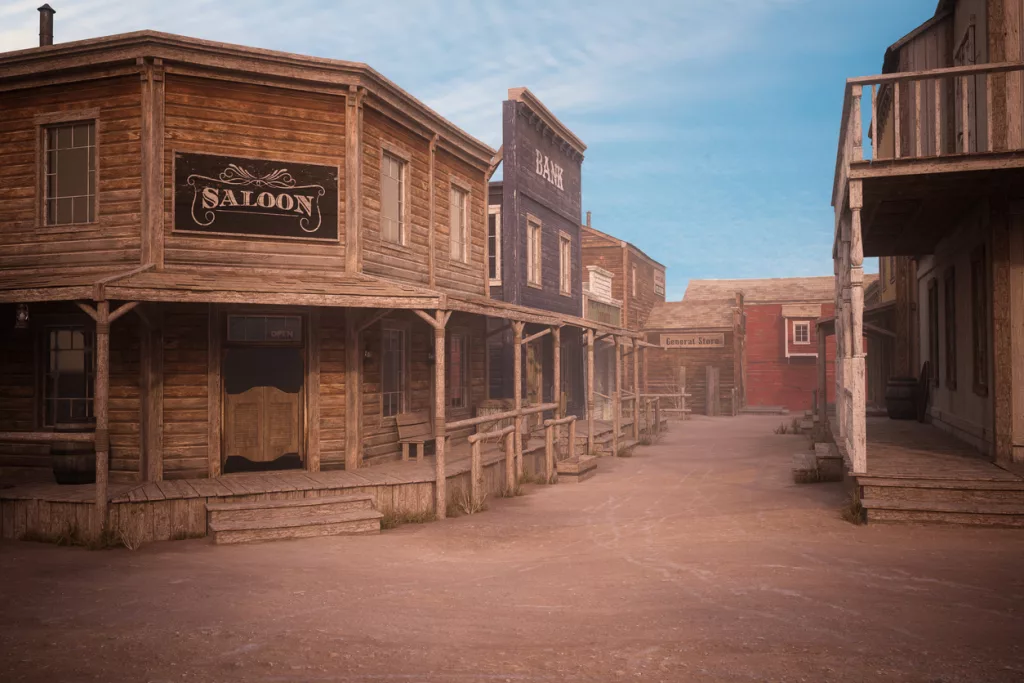 empty-dirt-street-in-an-old-western-town-with-various-wooden-buildings-3d-illustration