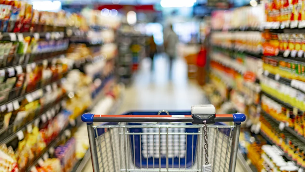 a-shopping-cart-by-a-store-shelf-in-a-supermarket