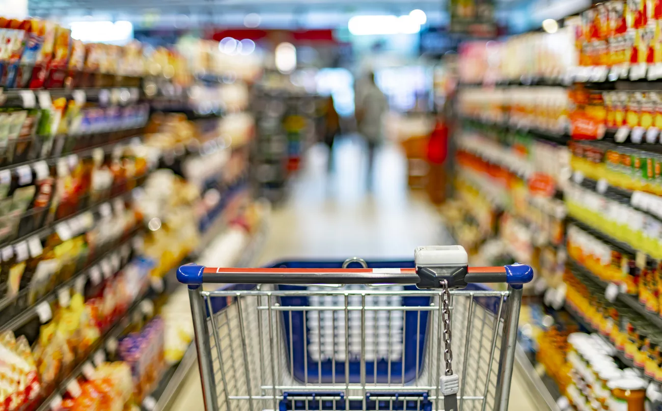 a-shopping-cart-by-a-store-shelf-in-a-supermarket